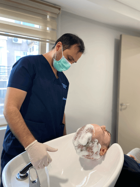 Dr. Utkan cleaning a patient's scalp