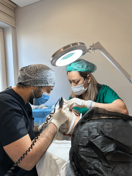 Dr Utkan performing hair restoration surgery